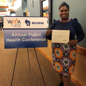 Lilliann Paine posing with her award from the Wisconsin Public Health Association