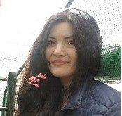 Woman with brown hair and glasses on head. Name is Andrea a Bilingual Healthy Communities Coordinator.